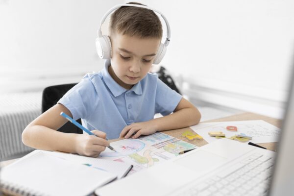 medium shot kid with headphones drawing